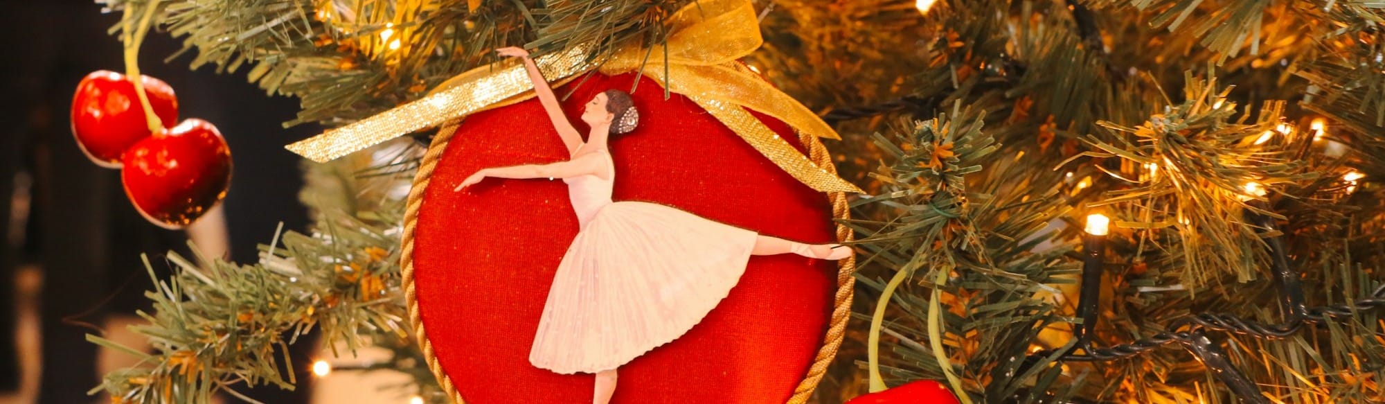 A christmas tree decorated with a red ballerina ornament