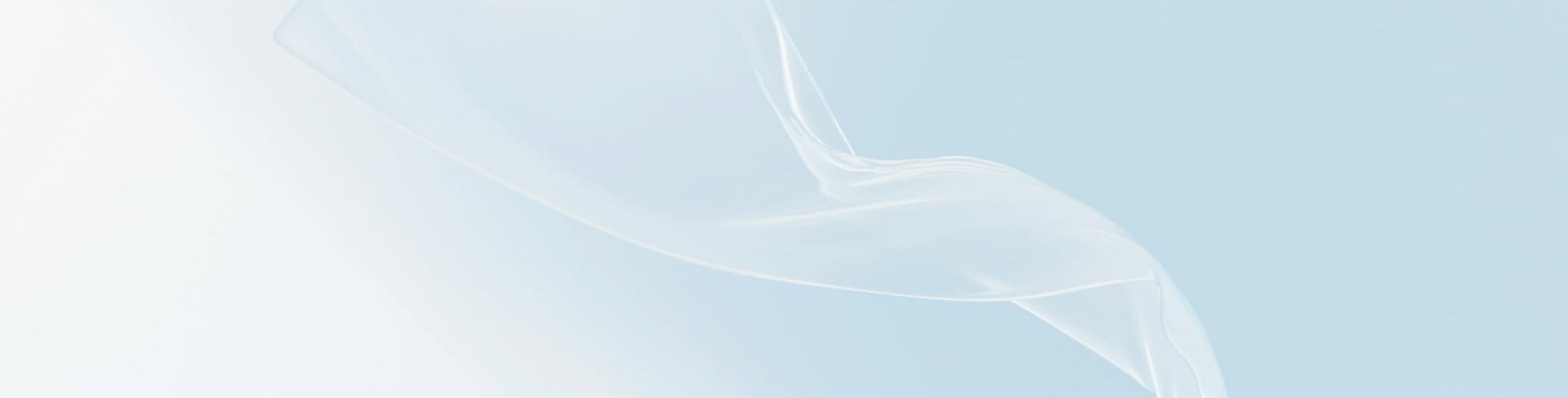 White fabric swirls in soft pastel light.