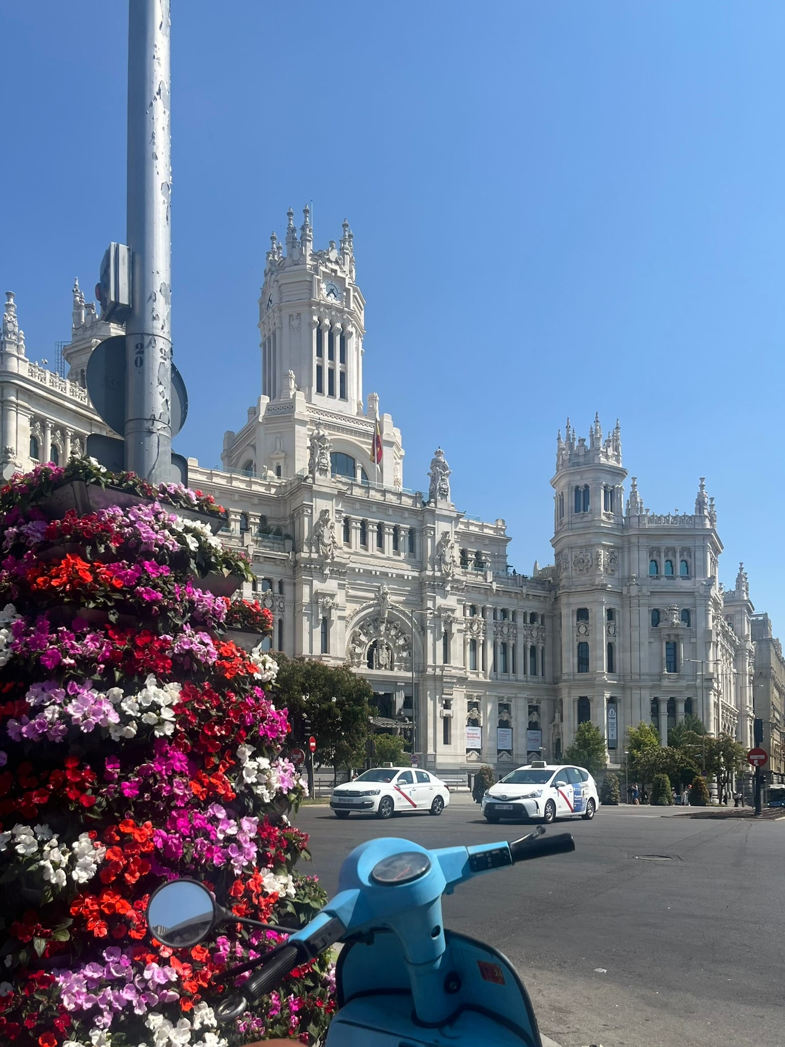 white heritage building, flowers and motorbike in front