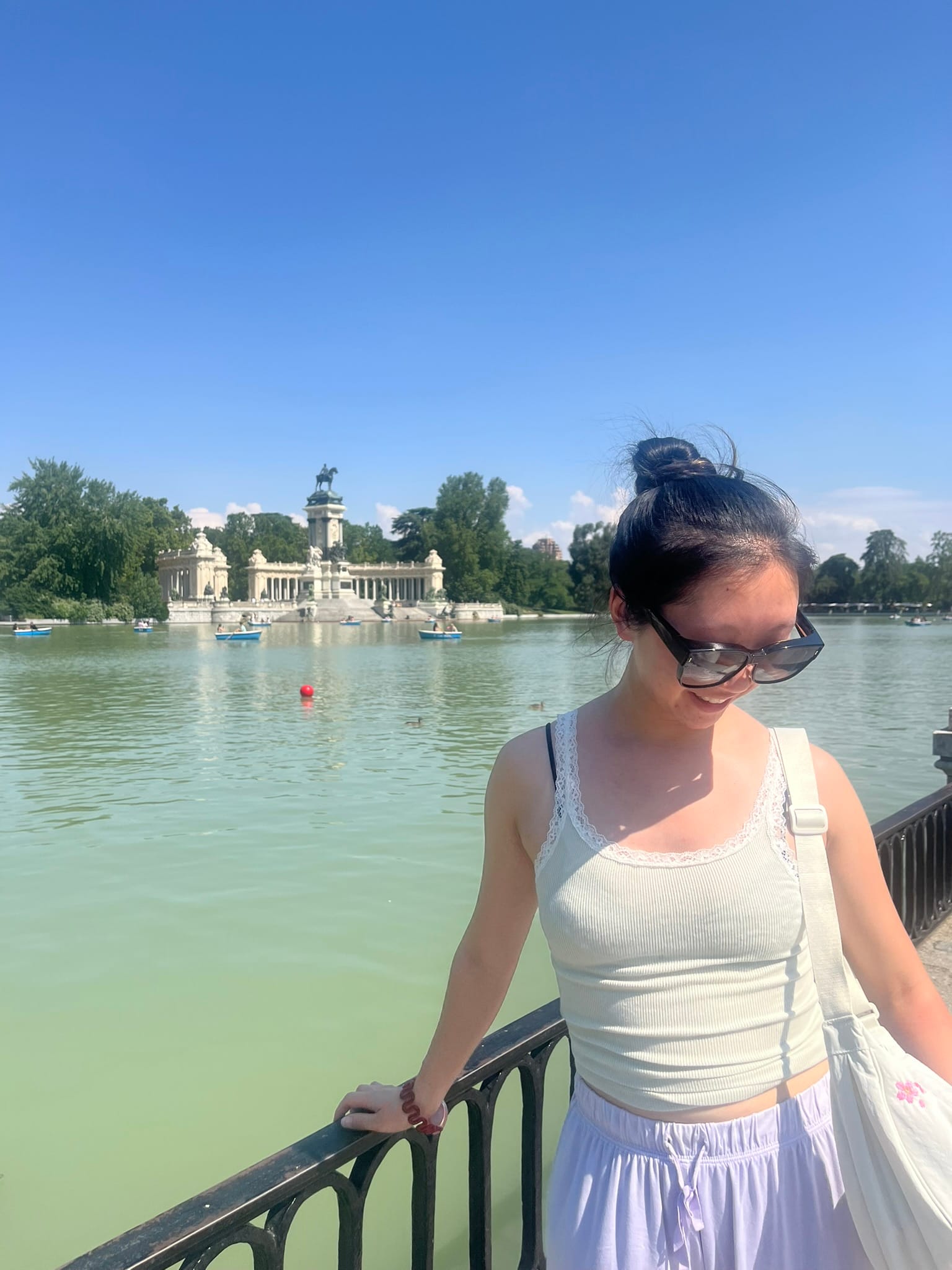girl smiling in front of wide pond