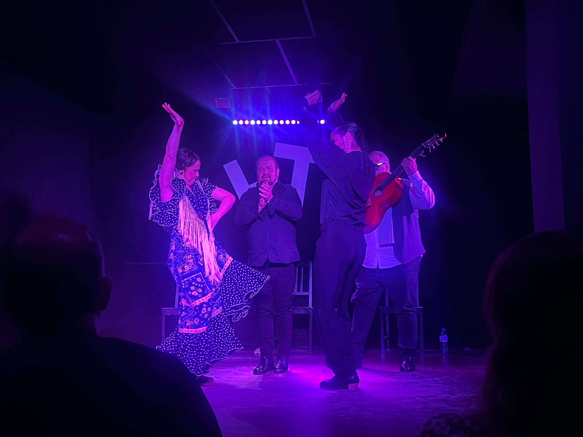 a woman and man dance and clap their hands