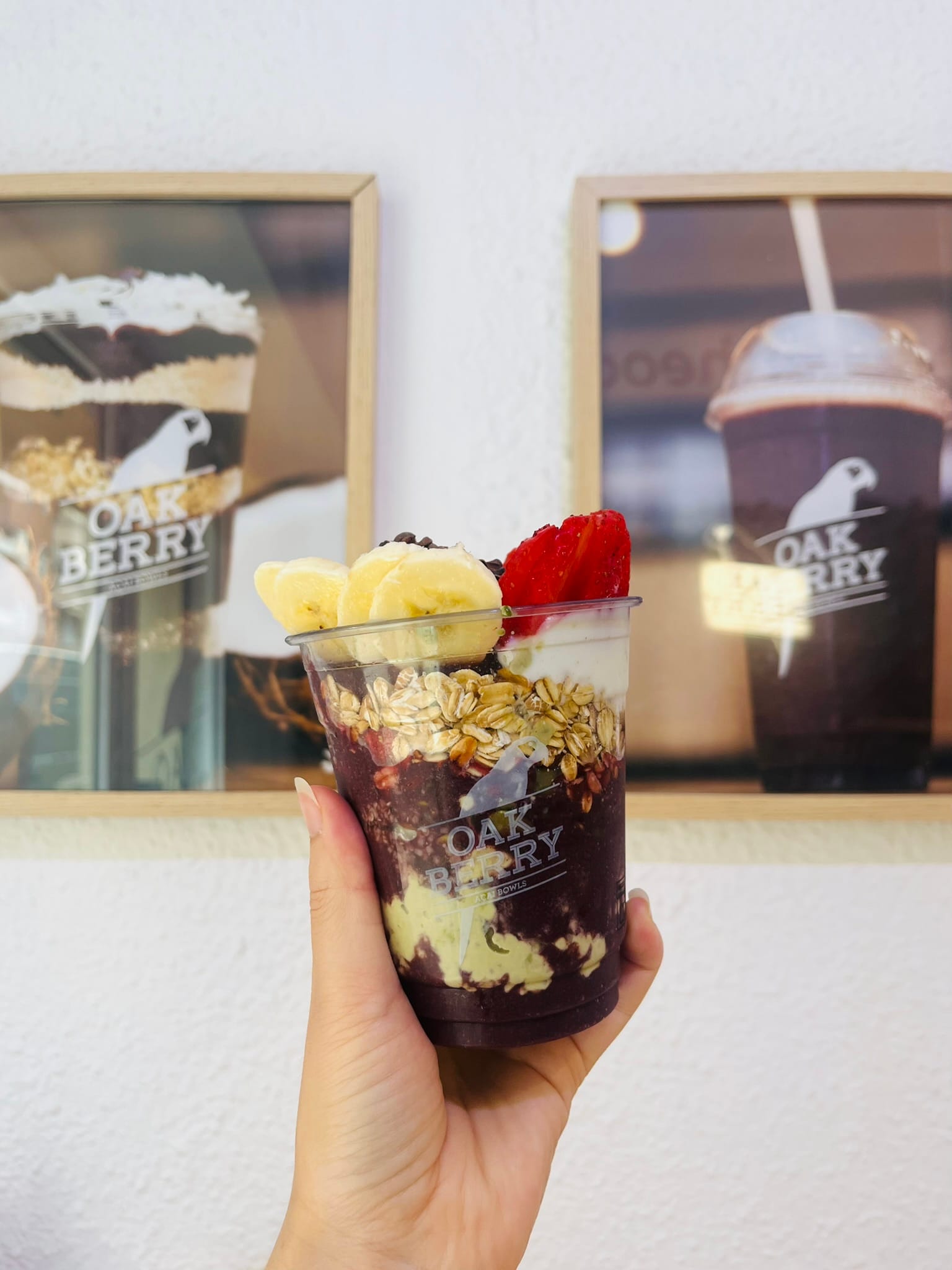 bananas, cocoa, granola, and strawberries in a cup