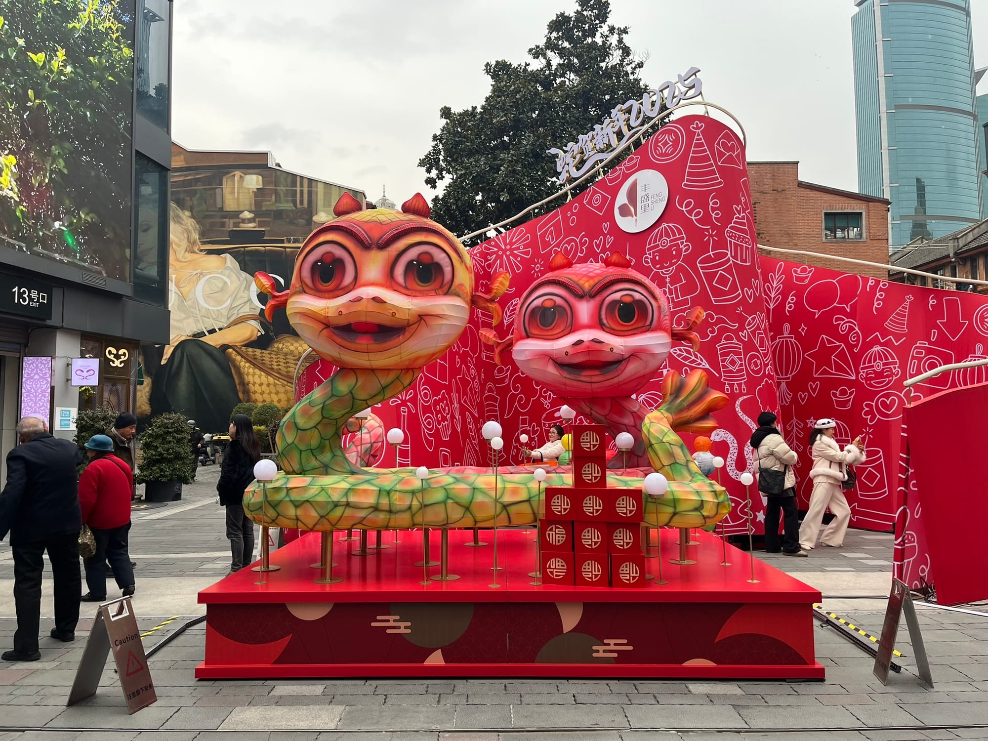 two snakes artwork display on a large red platform