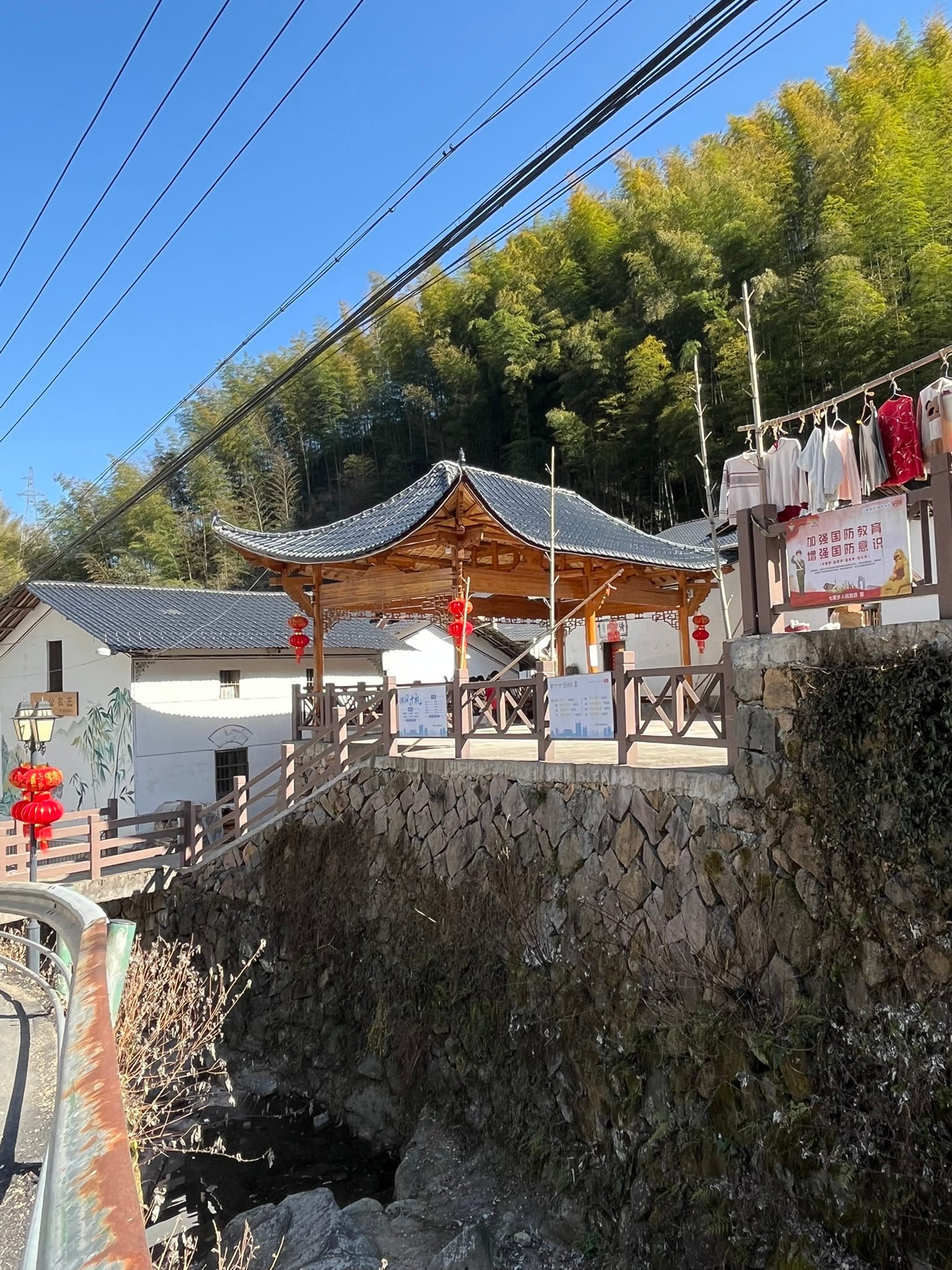 A pagoda by the river, telephone lines overhead