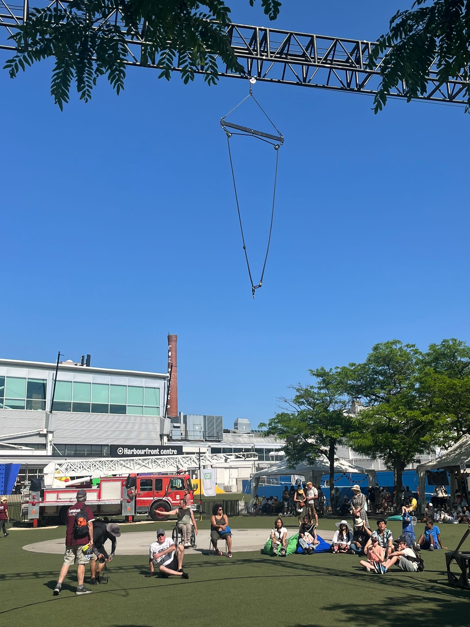 triangular wire contraption hanging from truss